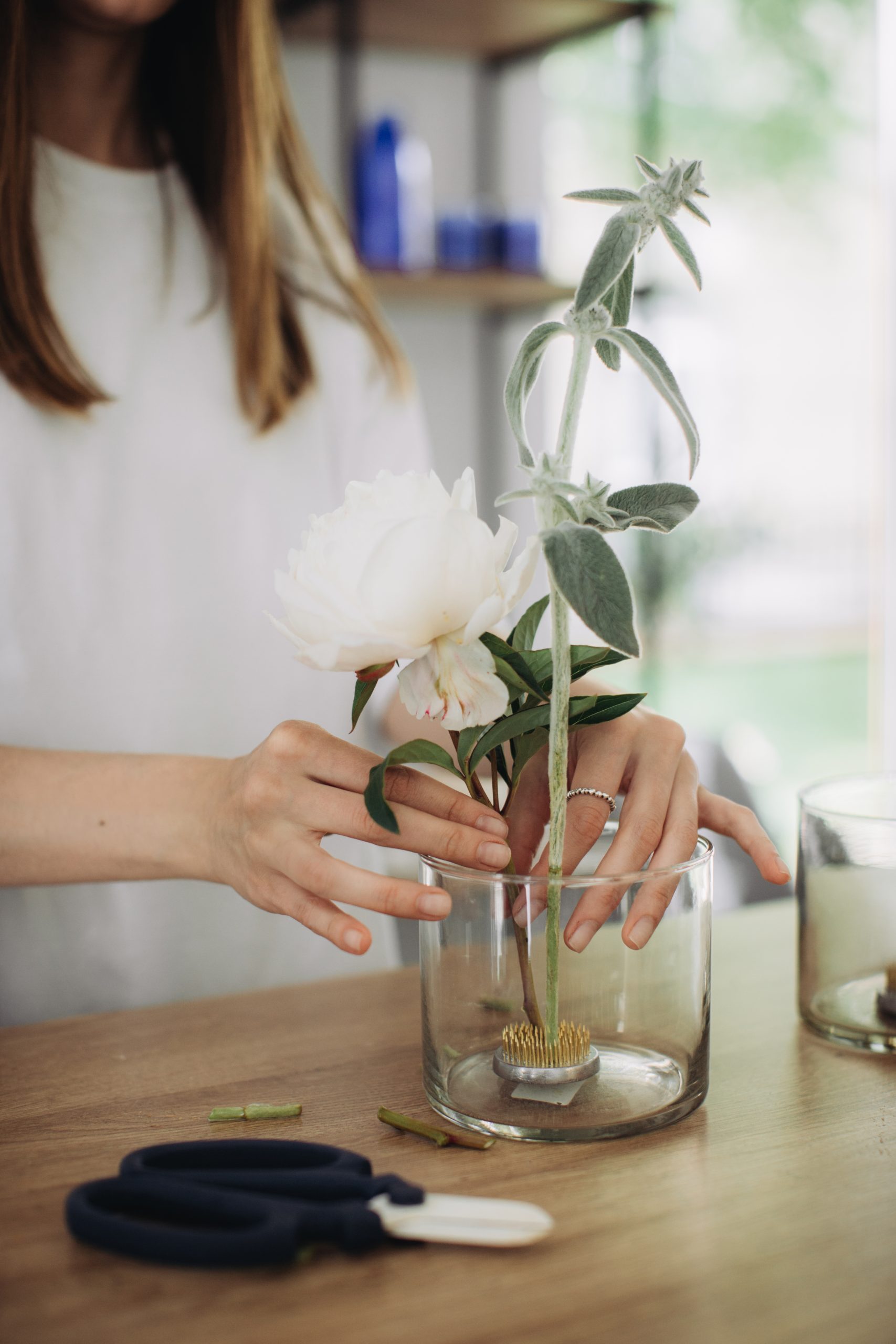 A florist makes a stylish flower arrangement on Kenzan.
